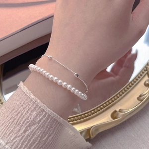 Elegant S925 sterling silver double-layer bracelet with pearls on a female wrist