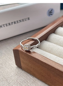 Detail shot of a square halo S925 sterling silver adjustable ring with a clear center stone