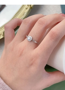 Detail of S925 silver square halo ring with unique chain link band worn by a model