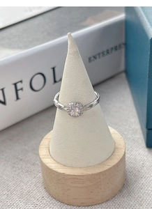 Macro view of S925 silver chain ring with square cut halo zircon on wooden jewelry stand