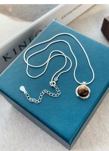 Macro shot of S925 sterling silver stamp on tiger eye stone pendant necklace
