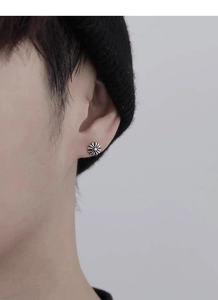 Macro view of vintage S925 sterling silver cross floral stud earring on model