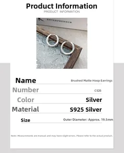 Macro detail of S925 sterling silver hoop earrings with brushed matte finish texture