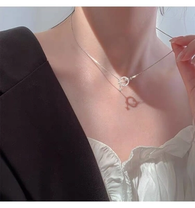 Macro detail of S925 silver planet necklace with OT clasp and heart-shaped shadow effect