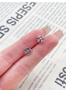 Close-up of S925 sterling silver cross studs with vintage finish and screw back closure