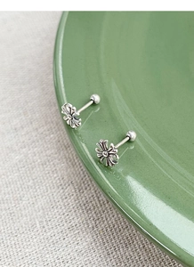 Detailed macro of S925 sterling silver cross studs with vintage finish and screw backs