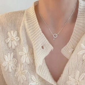 Detail of S925 sterling silver planet necklace with star pendant on a female model