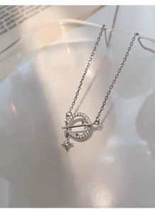 Macro detail of S925 silver planet necklace featuring hollow star pendant and sparkling zircon