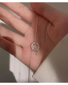 Close-up of S925 silver planet necklace with hollow ring pendant and zircon stars