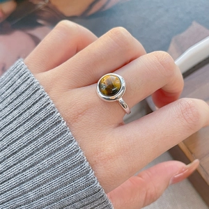 Minimalist S925 sterling silver geometric ring with a round tiger eye stone on finger