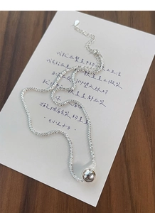 Detail of S925 sterling silver ball necklace showing the hallmark tag and lobster clasp