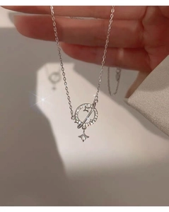 Close-up of S925 sterling silver planet necklace featuring sparkling cubic zirconia stars