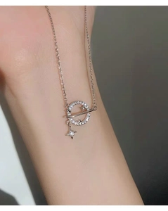 Detailed close-up of S925 silver planet necklace with sparkling cubic zirconia on skin