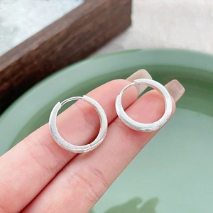 S925 sterling silver hoop earrings with a brushed matte finish shown on hand