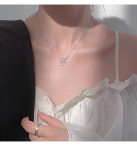 Detail of S925 sterling silver planet necklace with sparkling stars on female model