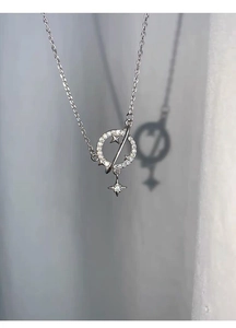 Detailed close-up of a S925 silver planet pendant with crystals and hollow stars