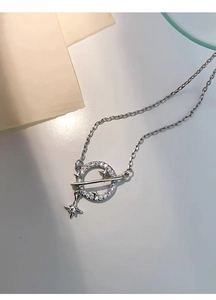 Macro shot of silver S925 planet necklace with sparkling cubic zirconia stars detail