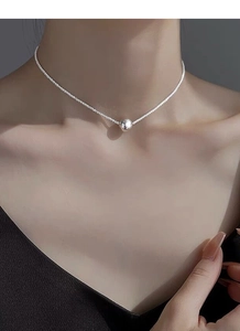 Detailed view of an S925 silver beaded choker necklace worn on a female neck