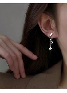 Close-up of S925 sterling silver dangling earrings with spiral design and star charm