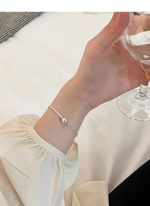 Detail of S925 sterling silver beaded bracelet on wrist with a lobster clasp closure