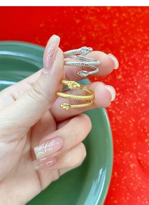 Macro detail of gold and silver S925 sterling silver dragon snake rings with scales