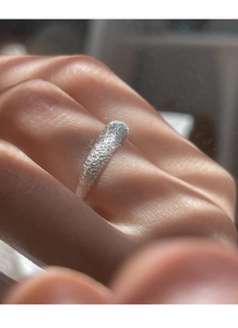 Close-up of S925 sterling silver frosted ring with a shimmering starry texture on a finger