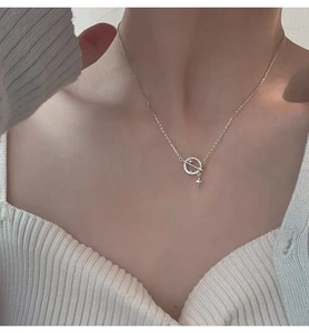 Close-up of S925 sterling silver planet necklace with crystal star pendant on a model