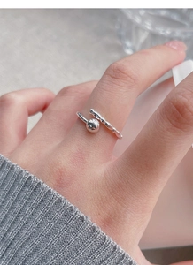 Detailed close-up of a minimalist S925 silver open ring with silver bead design