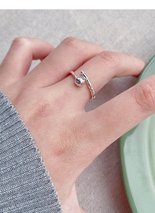 Detail of S925 sterling silver open ring with polished bead and beaded texture detail