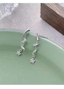 Detail of S925 silver spiral tassel earrings with sparkling star pendants in a dish