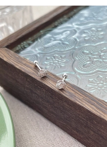 Close-up of S925 sterling silver camellia stud earrings with secure screw back closure