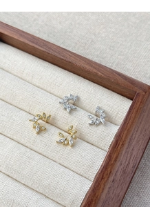 Detail of silver and gold wheat wreath earrings with micro-set zircon stones