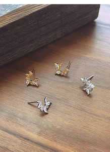 Detail of silver and gold laurel leaf earrings with sparkling marquise cut zircons