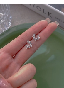 Macro shot of silver leaf earrings with shimmering marquise-cut cubic zirconia stones