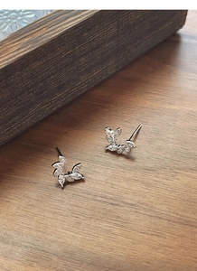 Detail of S925 silver leaf earrings with marquise and round white cubic zirconia stones