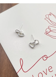 Close-up of S925 sterling silver hollow double heart earrings with irregular texture