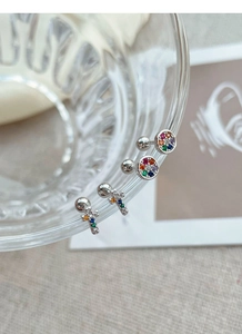 Detailed close-up of S925 silver cross and round studs with colorful zircon stones