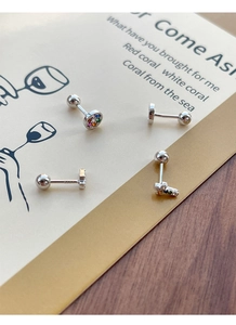 Macro view of S925 sterling silver cross and round studs with colorful zircon stones