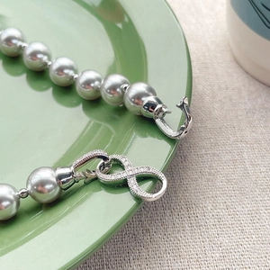 Silver grey pearl necklace with an infinity symbol clasp and sparkling zircon stones