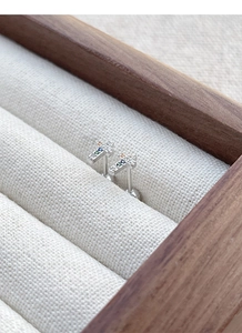 Macro view of S925 silver cross stud earrings with colorful zircon and screw backs