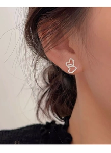 Detailed view of S925 sterling silver double heart earrings with hammered texture on ear