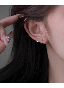 Close-up of S925 silver round cross stud earrings with colorful stones on model's ear