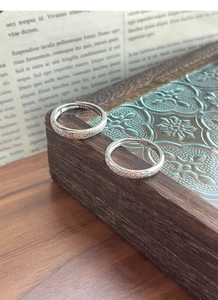 Detail of S925 sterling silver stamp and frosted texture on minimalist open couple rings