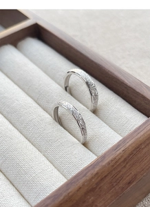 Close-up of frosted S925 sterling silver couple rings showing the starry sand finish