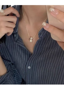 Elegant S925 silver necklace with white pearl pendant and matching pearl ring on a model