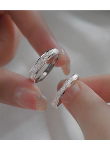 Macro shot of silver S925 sterling silver frosted couple rings with adjustable band detail