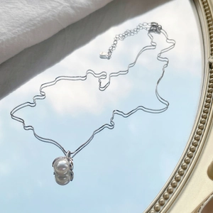 Minimalist S925 sterling silver necklace with single white pearl on reflective mirror