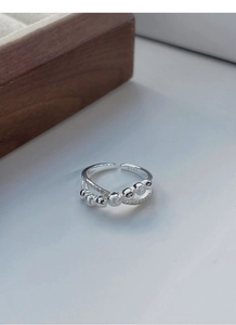 Close-up of S925 sterling silver double-layer ring with pavé cubic zirconia and frosted beads