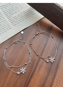 Macro shot of S925 sterling silver stamp on heart tag of a double-layer flower bracelet