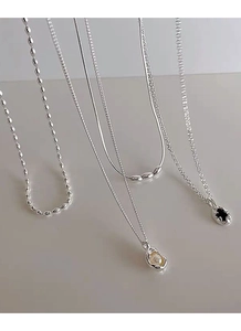 Detailed showcase of S925 silver necklaces with pearls and pendants in various layered styles